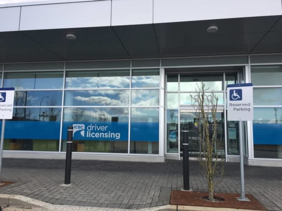 Exterior of an ICBC driver licensing office with accessible parking signs